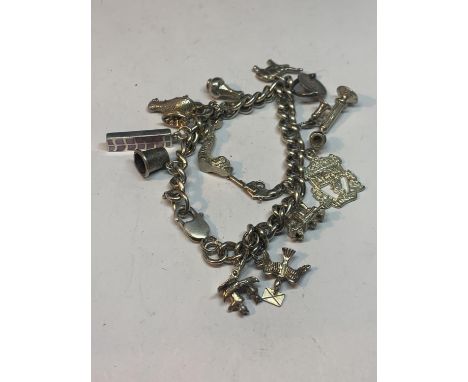 A SILVER BRACELET WITH THIRTEEN CHARMS A GENIE LAMP, LIVERPOOL FOOTBALL CLUB BADGE, ELEPHANT, VINTAGE PHONE, PISTOL ETC 