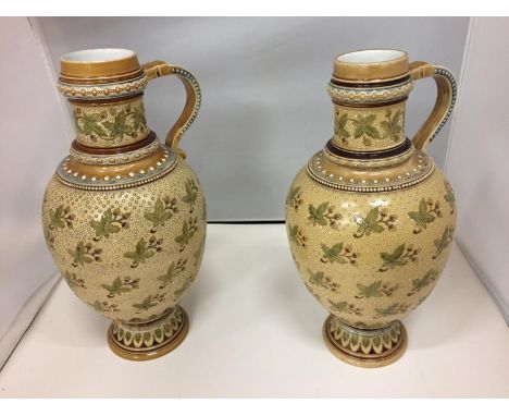 A PAIR OF TALL CERAMIC DECORATIVE SINGLE HANDLED JUGS HEIGHT 34CM 