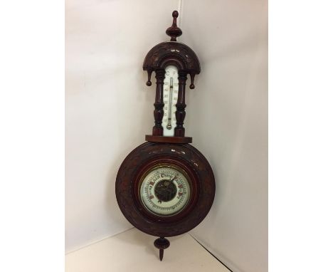 AN ORNATE WALL BAROMETER 