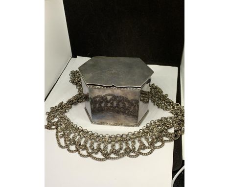 A SILVER PLATED LIDDED TEA CADDY AND AN ORNATE WHITE METAL BELT 