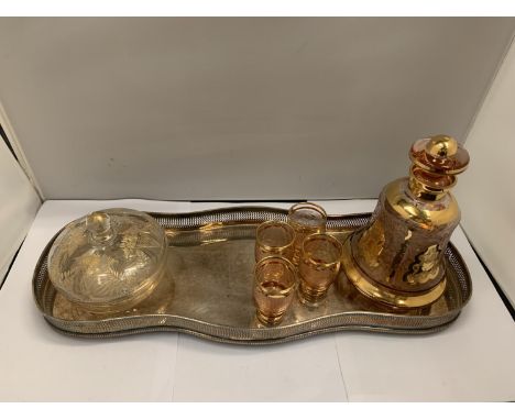 A SILVER PLATED TRAY WITH ORNATE DECANTER, FOUR GLASSES AND A LIDDED JAR 