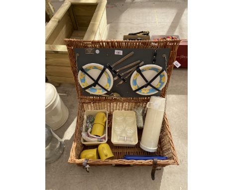 A WICKER PICNIC HAMPER WITH PLATES, CUTTLERY AND CUPS ETC 