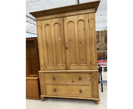 A VICTORIAN PINE HOUSEKEEPER CUPBOARD HAVING PANNELED DOORS TO THE UPPER SECTION AND TWO DRAWERS TO THE BASE 65" WIDE THE UPP