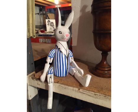 A WOODEN PAINTED SHELF PUPPET OF A RABBIT 