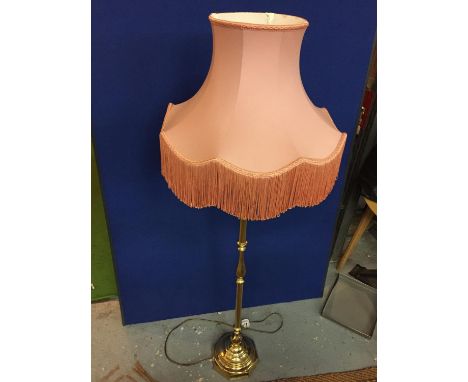 A BRASS STANDARD LAMP WITH PINK SHADE 