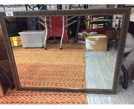 A MODERN GILT AND BLACK STRIPE PATTERNED FRAMED MIRROR SIZE 65CM X50CM 