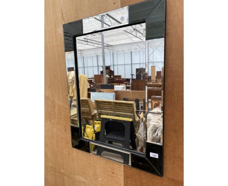 A DECORATIVE FRAMED MIRROR 