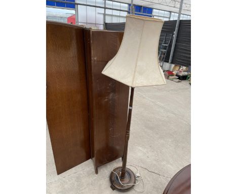 AN OAK STANDARD LAMP WITH SHADE 