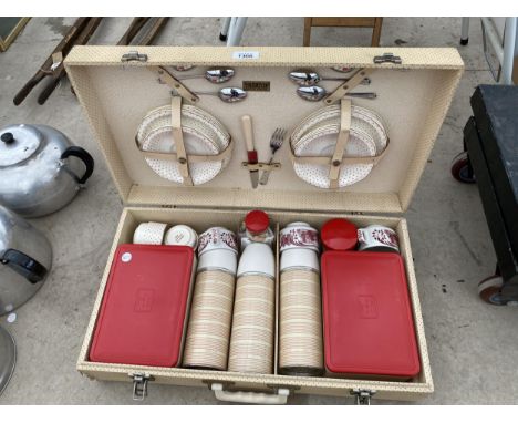 A RETRO PICNIC HAMPER WITH PLATES, FLATWARE AND CUPS ETC 