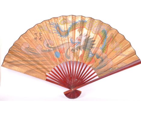 A large vintage 20th century Chinese oriental hand painted and red lacquer wall fan with Chinese dragon decoration.&nbsp;meas