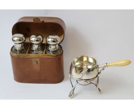 Silver brandy warmer with wirework stand for a lamp by Gibson & Langman 1888 and a set of three mounted glass bottles in leat