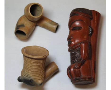 Early 20th century tribal terracotta figural pipe bowl, 14.5cm high and two African terracotta pipe bowls , one with double c