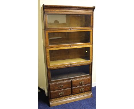 Globe Wernicke oak bookcase with four glazed sections with four short drawers below. 86cm wide x 174cm high. 