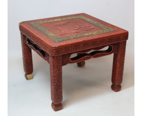 Small Chinese cinnabar lacquer stand of square form decorated with precious things on a lattice ground surrounded by gilt scr