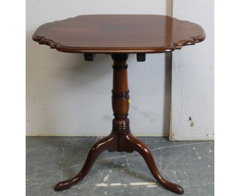 Victorian mahogany tripod table, the shaped rectangular top raised on turned column and tripod base on pad feet. 65cm 