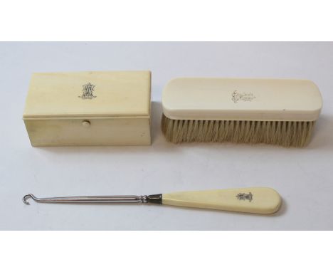 Safety razor in silver mounted ivory case, 1926, and a similar button hook and hair brush.