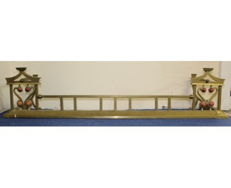 Arts and Crafts brass fender with stylised ends inset with Ruskin style cabochon roundels. 133cm wideCondition:No obvious dam