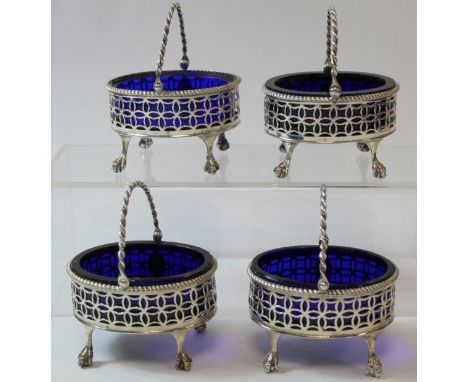 Set of four oval pierced salts, straight sided with swing handles, upon ball and claw feet, crested, by R & D Hennell 1769. 1