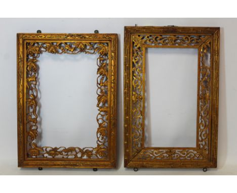 Two Chinese pierced giltwood frames, one with lotus flower, foliate scroll and Greek key borders, 34cm x 23cm, to fit image 2