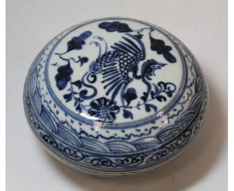 Chinese Qing dynasty blue and white porcelain circular covered box decorated with a phoenix amongst flowers and foliage with 