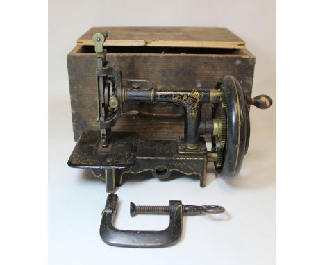 Antique German miniature manual cast iron sewing machine with black japanned and gilt decoration by I. Schroder, Darmstadt. 1