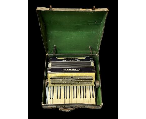 A Hohner Carmen II piano accordion in fitted case.