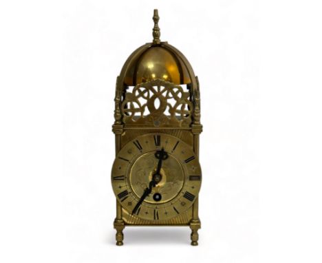 A small brass lantern clock, marked inside 'S F 8 days'. Sold as found. Height 27cm.