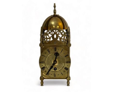 A small brass lantern clock, marked inside 'S F 8 days'. Sold as found. Height 27cm.