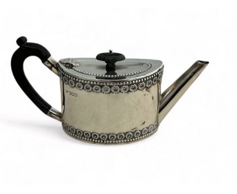 A silver bachelor's teapot of straight sided oval form, ebonised wood handle and finial. Fordham &amp; Faulkner, London 1897.