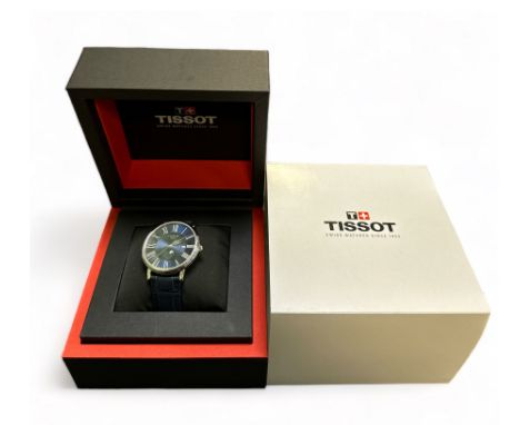 Tissot T-Classic Carson 40mm Moon Phase Men's Watch, features a blue dial with Roman numerals and date aperture, stainless st