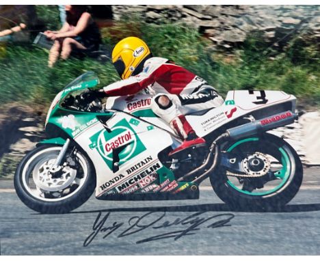 Framed signed Joey Dunlop picture. Dunlop is a Isle of Man TT legend, with 26 wins. Voted N.Ireland's greatest sports star in