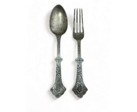 A silver Christening fork and spoon decorated with a bird (stork?) and leaf design by Thomas Smily, 1879. 