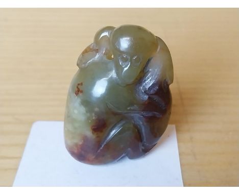 A Chinese carved jade mother monkey and her baby. 