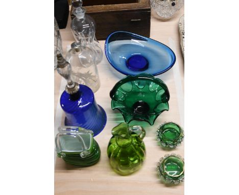 A collection of coloured art glass, including a cobalt glass hand bell, Bohemian enamelled glass salts and a decanter. 