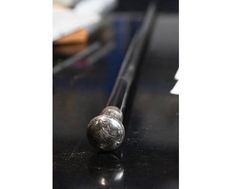 A ebony swagger stick with a silver plated pummel and engraved monogram. 