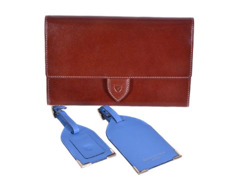 Aspinal of London, a red leather travel document case, the single flap with button clasp, opening to a suede interior, compar