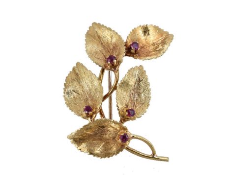 A 1970s 18 carat gold and ruby leaf brooch, the textured leaves each set with a circular cut ruby, stamped 750 with import ma