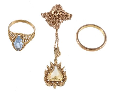 A citrine pendant, the triangular cut citrine claw set within a textured abstract leaf surround, on a belcher link chain, sta