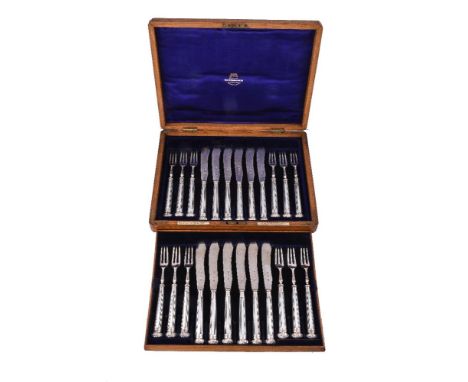 ϒA set of twelve late Victorian silver and mother of pearl fruit knives and forks by The Goldsmiths & Silversmiths Co. Ltd, L