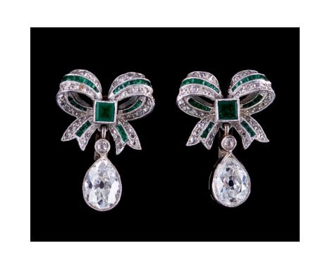 A pair of earrings, Platinum and gold, Bow set with calibrated emeralds, rose cut diamonds and 2 antique brilliant cut diamon