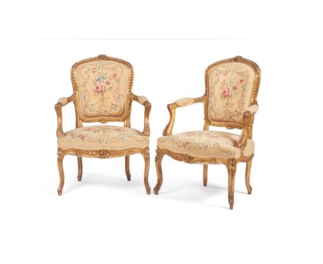 A pair of Louis XV style fauteuils, Carved and gilt wood, Floral and foliage motifs tapestry upholstered seats and backs, Fra