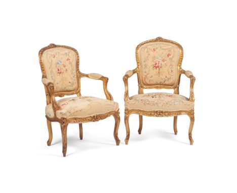 A pair of Louis XV style fauteuils, Carved and gilt wood, Floral and foliage motifs tapestry upholstered seats and backs, Fra