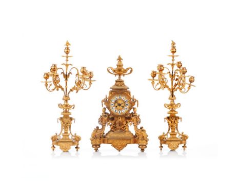 A Napoleon III garniture, Comprising of table top clock and pair of six branch candelabra, Gilt and reliefs bronze of profuse