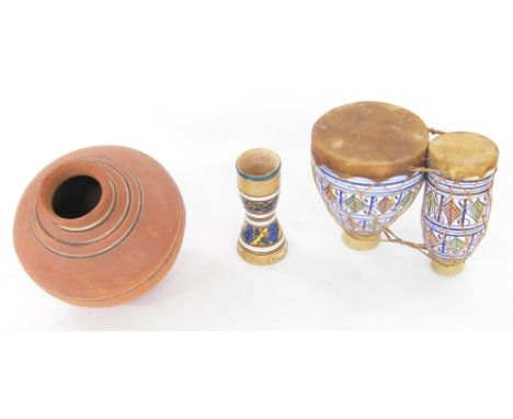 Interesting set of blue and white ceramic bongo drums with gut skin and tension; together with two further clay drums (3) 