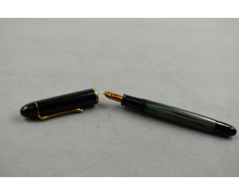 A Pelikan 140 piston fill fountain pen in green striated pattern and black cap having Pelikan 14ct nib. Approx 12.4cm