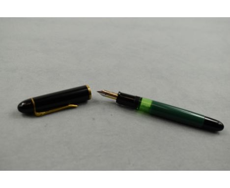 A Pelikan 120 piston fill fountain pen in green with black cap having Pelikan EF nib. Approx 12.4cm