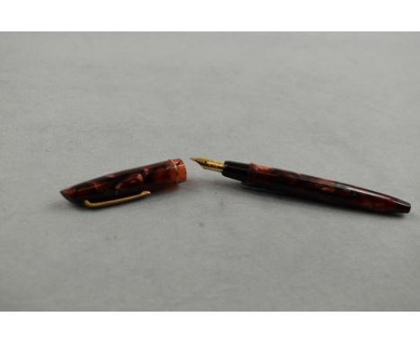 A Gold Starry piston fill fountain pen in red/pink marble with single band to the cap having Nox 2 nib. Approx 10.4cm