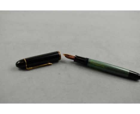 A Pelikan 140 piston fill fountain pen in green striated pattern and black cap having Pelikan 14ct nib. Approx 12.4cm