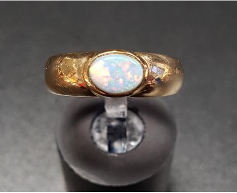 OPAL SINGLE STONE RINGthe bezel set opal on nine carat gold shank, ring size L-M 