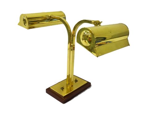 DOUBLE BRASS DESK LAMPraised on a rectangular base with two shaped columns and two adjustable lamp hoods 